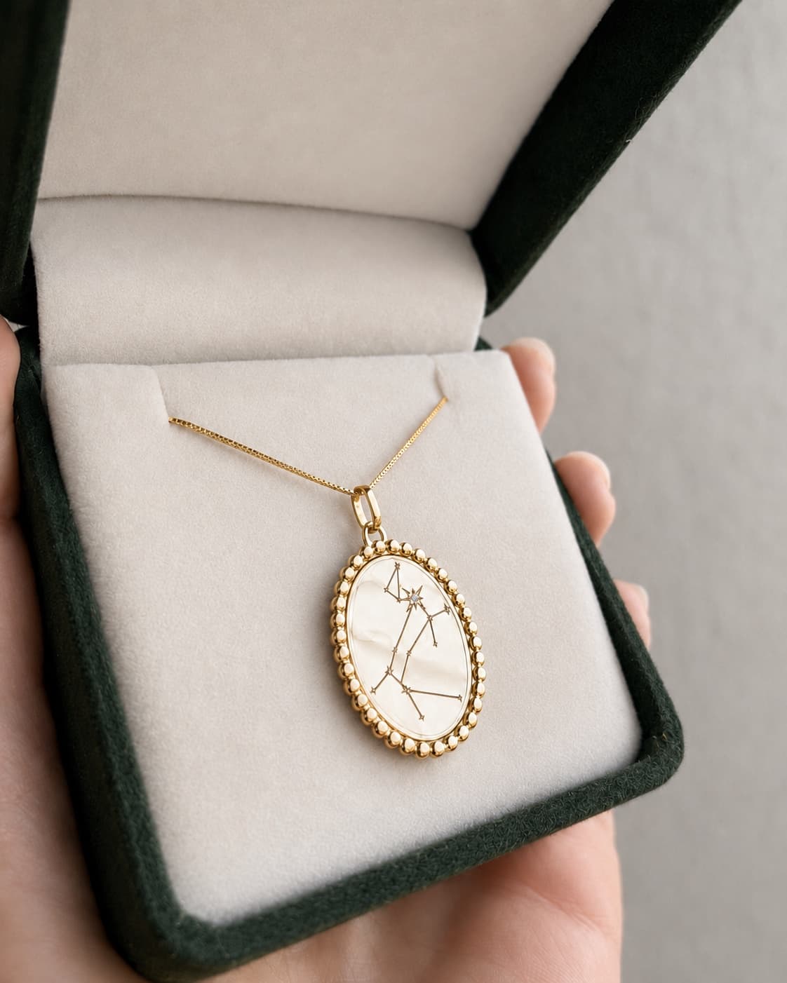 Pingente Divinita em ouro amarelo com a constelação do Cão Maior e um diamante no ponto mais brilhante, dentro do estojo